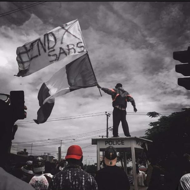 Man carrying Nigerian flag during #EndSARS protest