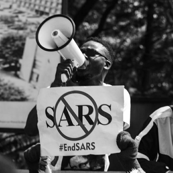 Man with banner displaying #EndSARS