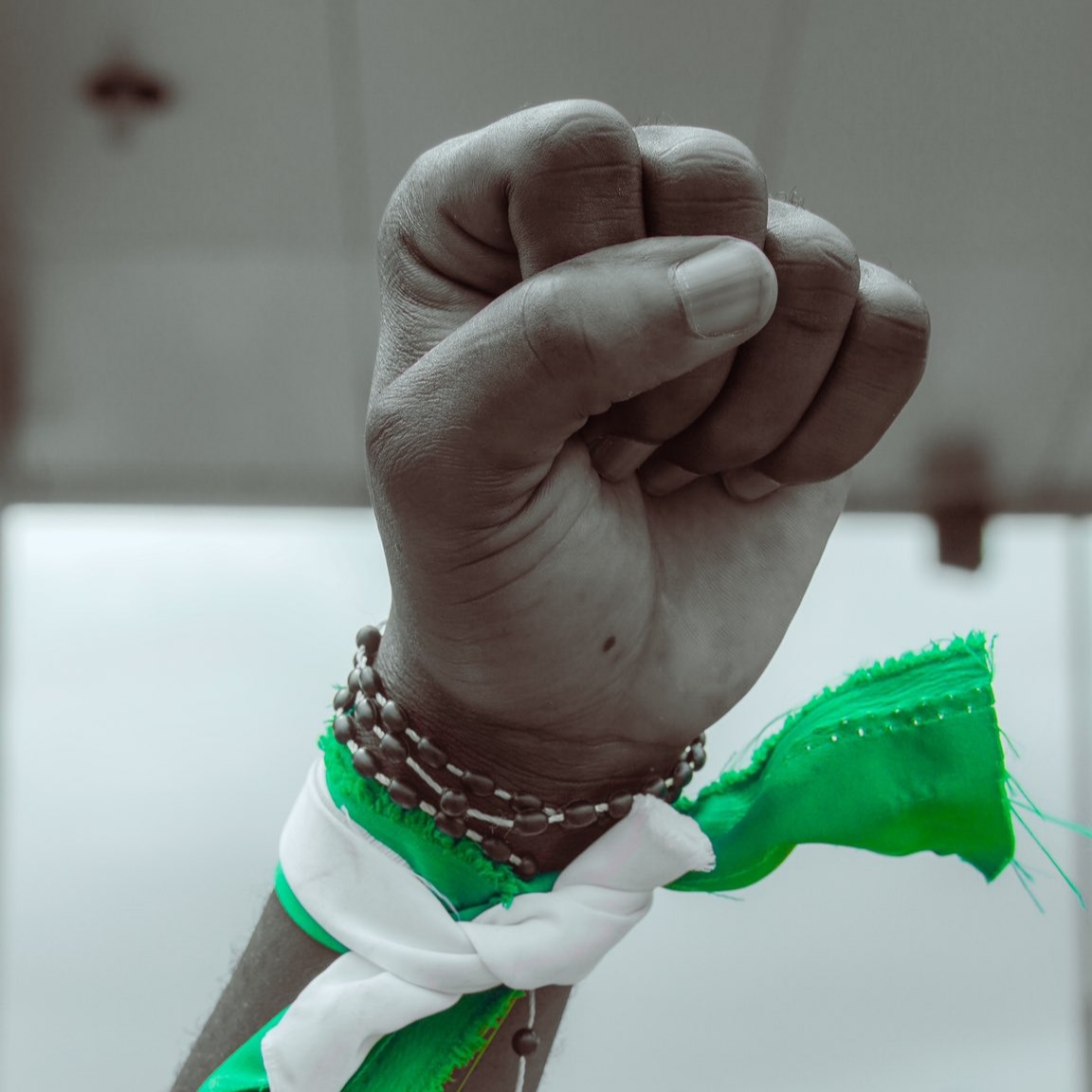 African man folded fist tied with the Nigerian flag