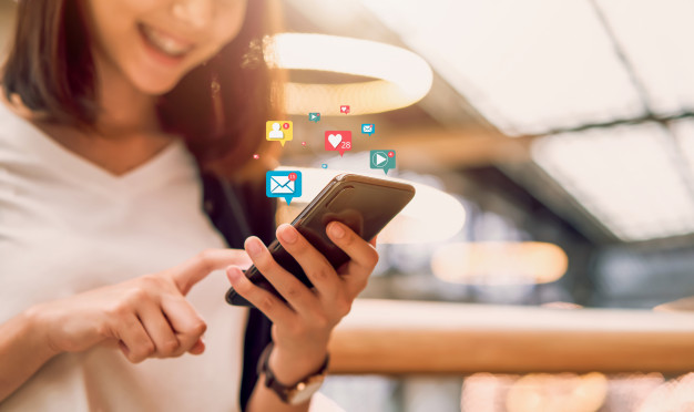 Smiling Asian woman using smartphone