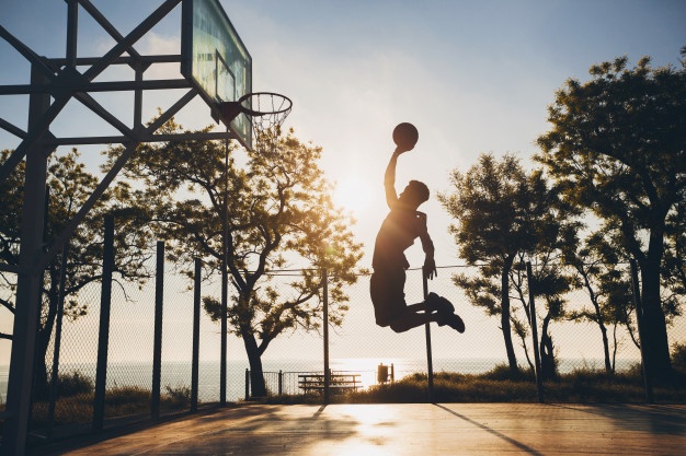 black man doing sport playing basketball