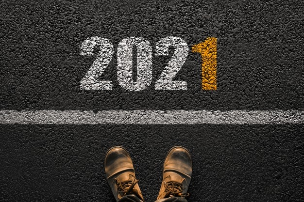 Male feet with boots on asphalt with white line number:2021