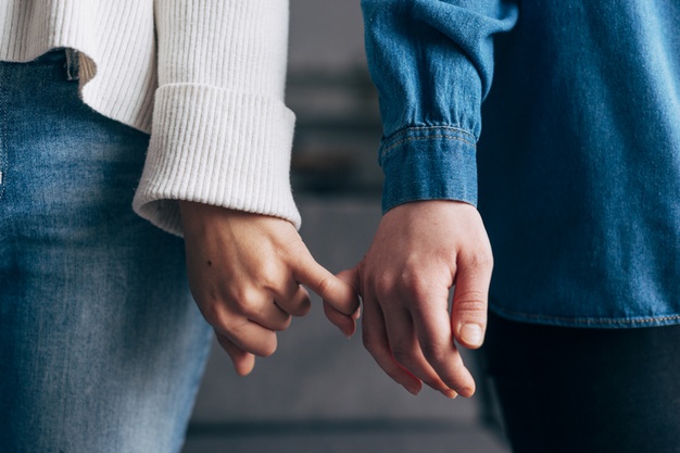 Male and female holding hands