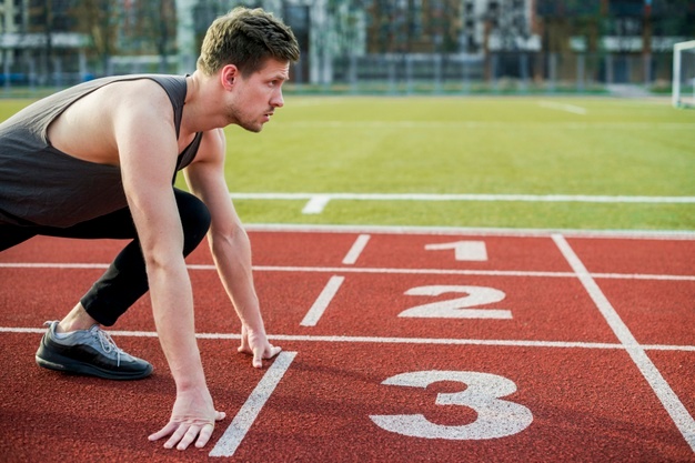 Young male athlete on the start line