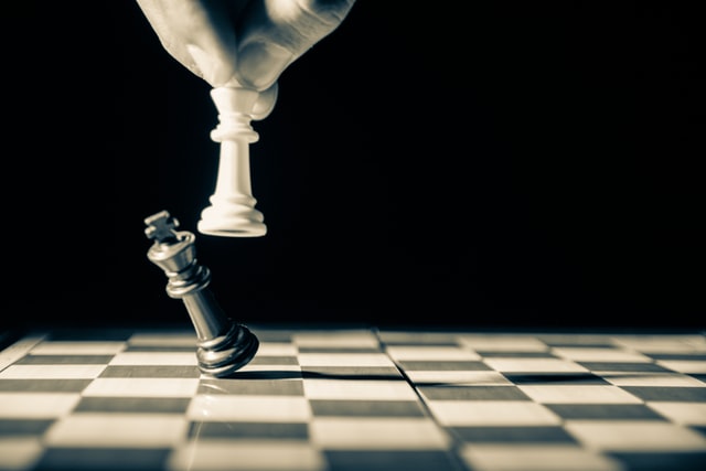 Black chess piece falling