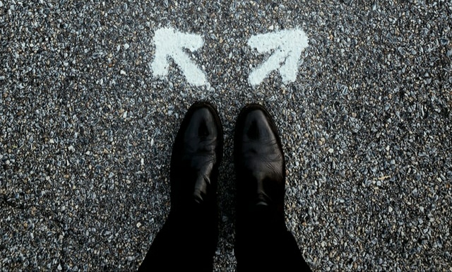 Man's shoe on two-way direction line