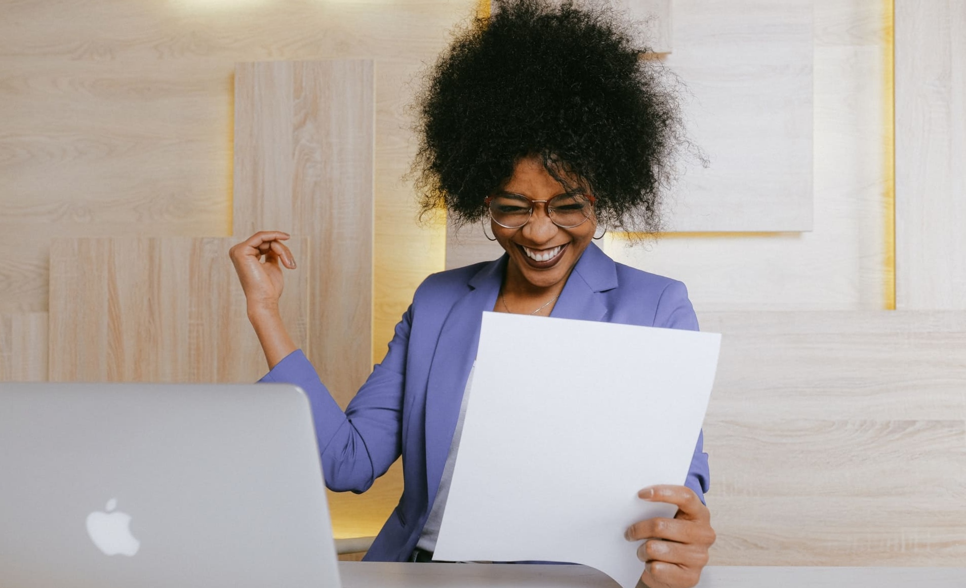 Black employee happy holding booklet