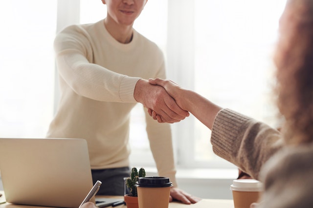 Recruiter shaking hands with interviewee