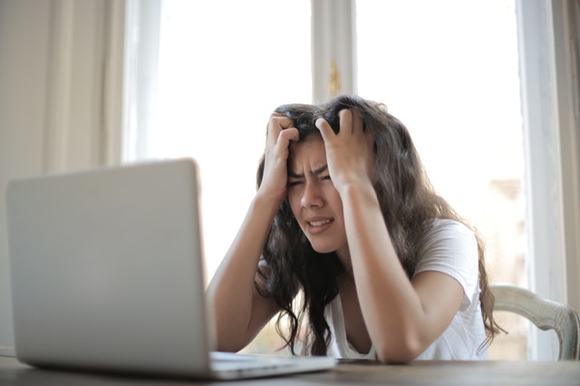 Worried lady with her hands on her head