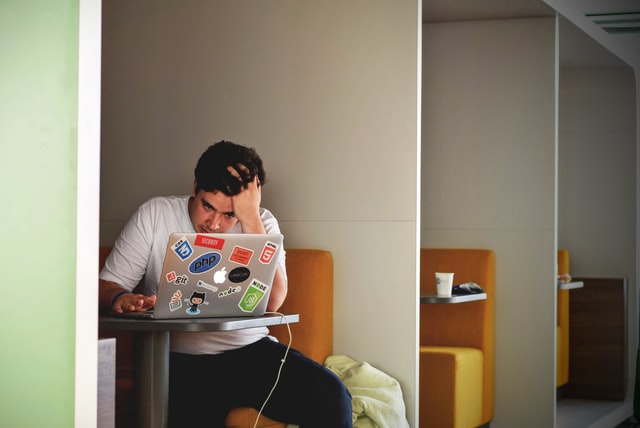 Exhausted worker working on his Laptop