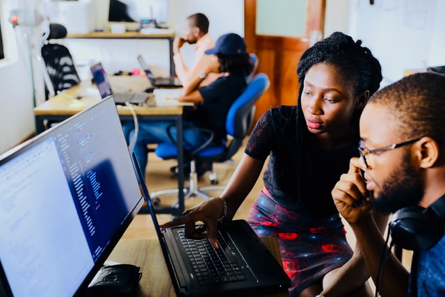 Male and female tech enthusiast operating a desktop