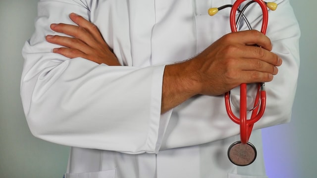 Medical Doctor holding red stethoscope