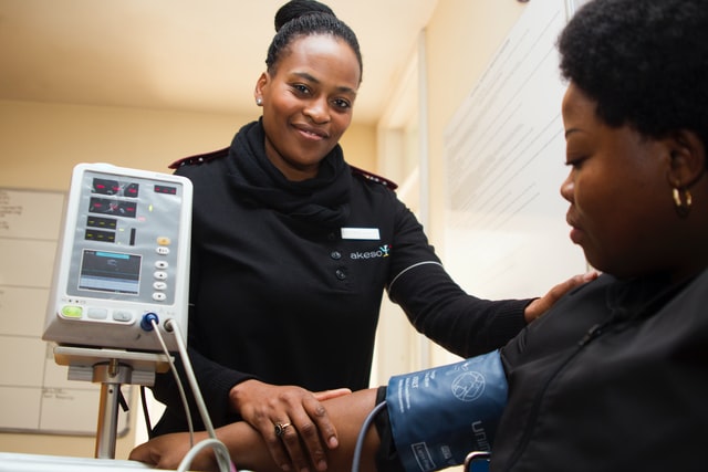 African-American health care woman checking up on patient