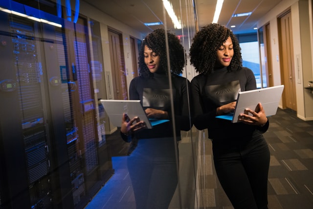 African American woman using her laptop while standing