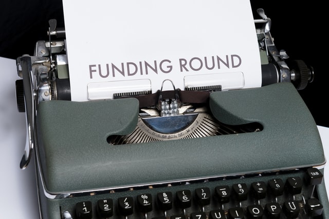 Typewriter with the words "funding round"